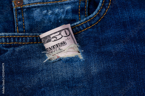 Dollars in a denim hole