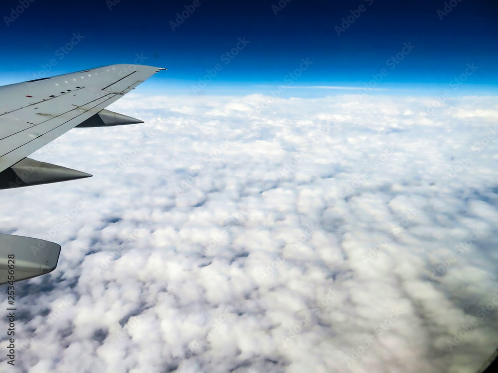 airplane wing on a background of clouds airplane wing on a background of clouds