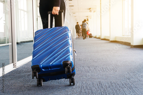Fényképezés Traveler women and luggage at airport terminal Travel concept