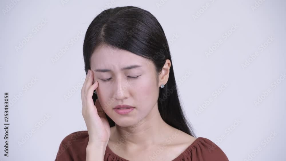 Face of serious Asian woman thinking and looking down Face of serious Asian woman thinking and looking down