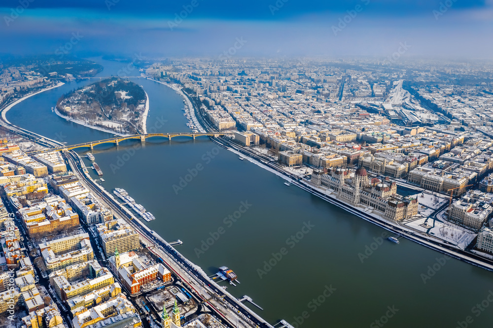 Budapest, Hungary - Winter morning over Budapest with snow, Parliament building, Margaret Bridge and Margaret Island