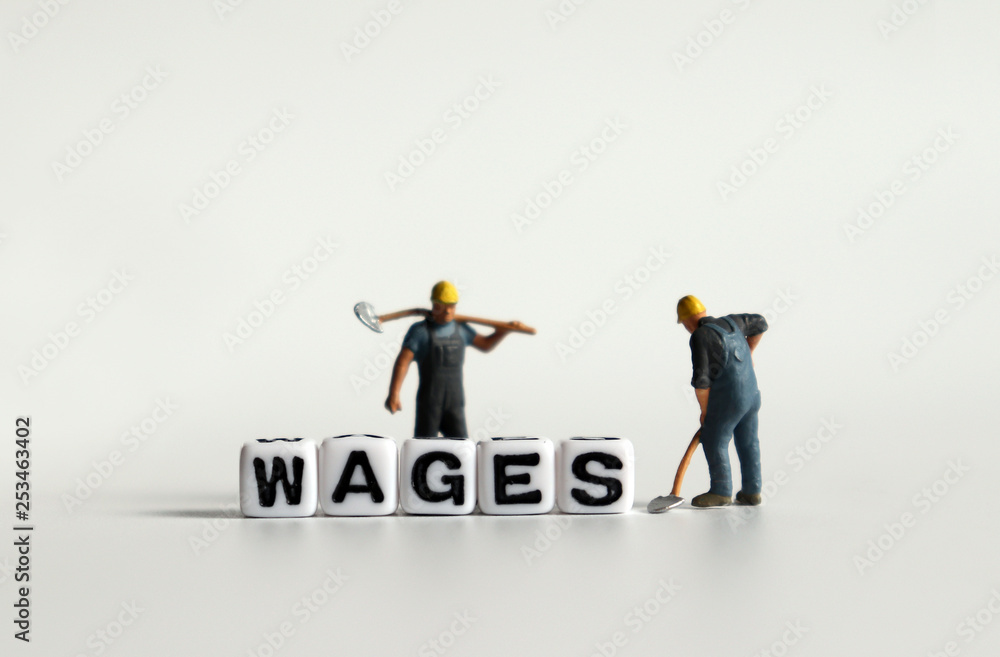 Fototapeta premium 'WAGES' word in white cube. Miniature people.