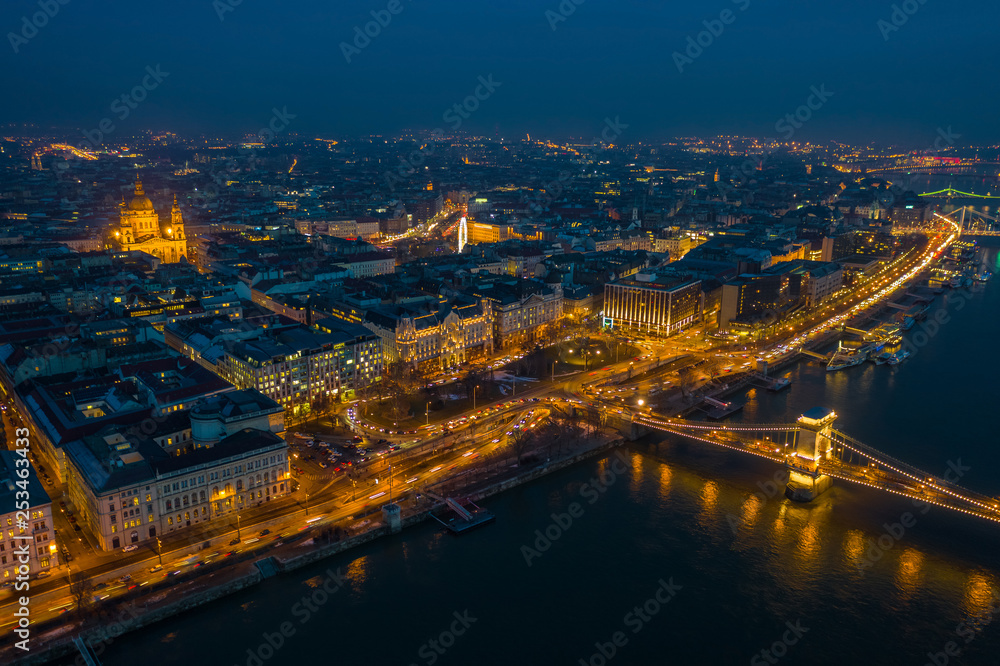 Budapest, Hungary - Aerial skyline view of Pest side of Budapest with illuminated Szechenyi Chain Bridge and St. Stephen's Basilica at blue hour