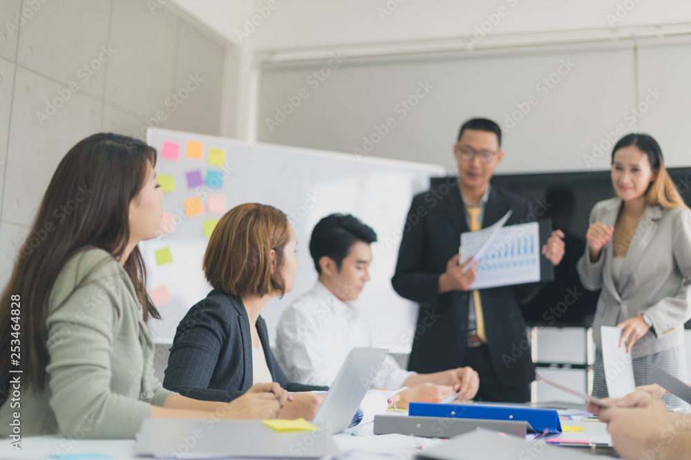 A group of Asian businessmen are discussing.