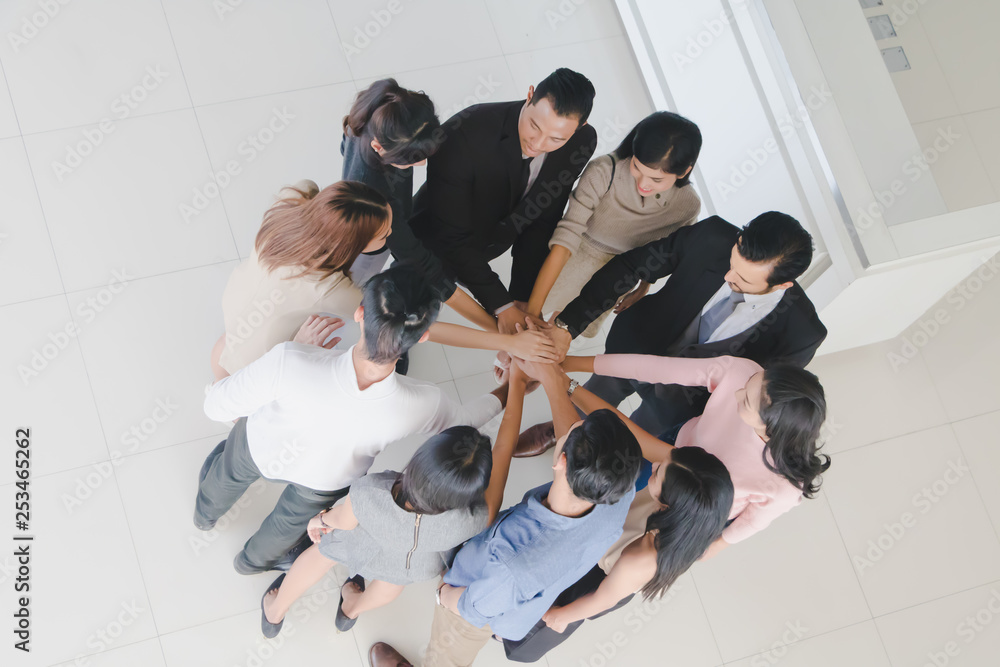 Male and female businessmen join hands in the hall of office.Top view. Male and female businessmen join hands in the hall of office.Top view.
