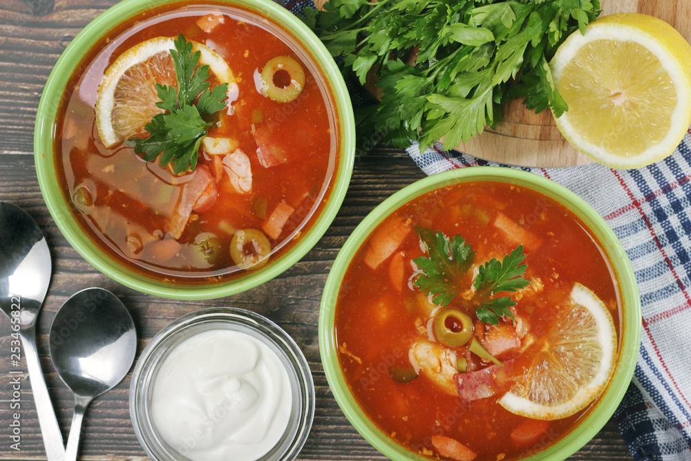 Two bowls with traditional Russian soup solyanka Two bowls with traditional Russian soup solyanka
