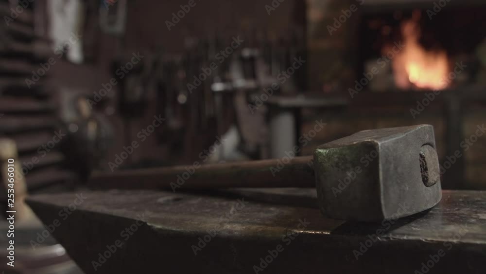 Blacksmith forges iron in fire Blacksmith forges iron in fire