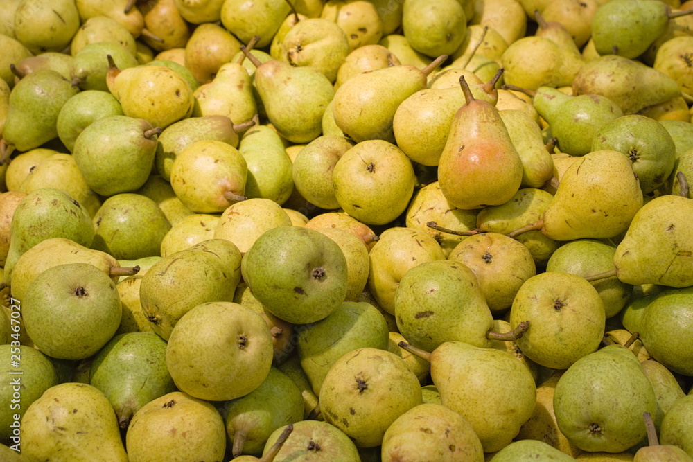Small ripe green pears lie in a bunch Small ripe green pears lie in a bunch