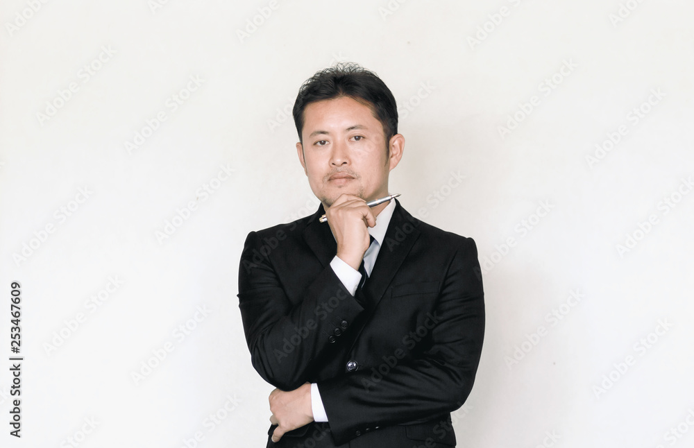 young business man thinking with holding pen. young business man thinking with holding pen.