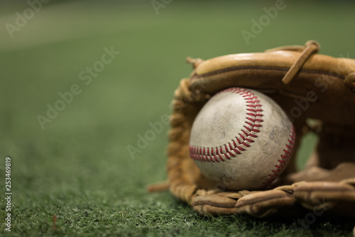 Baseball mitt and baseball on turf