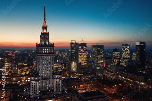 Aerial view of the business center of Warsaw: Palace of Science and Culture and skyscrapers in the evening © vladstar