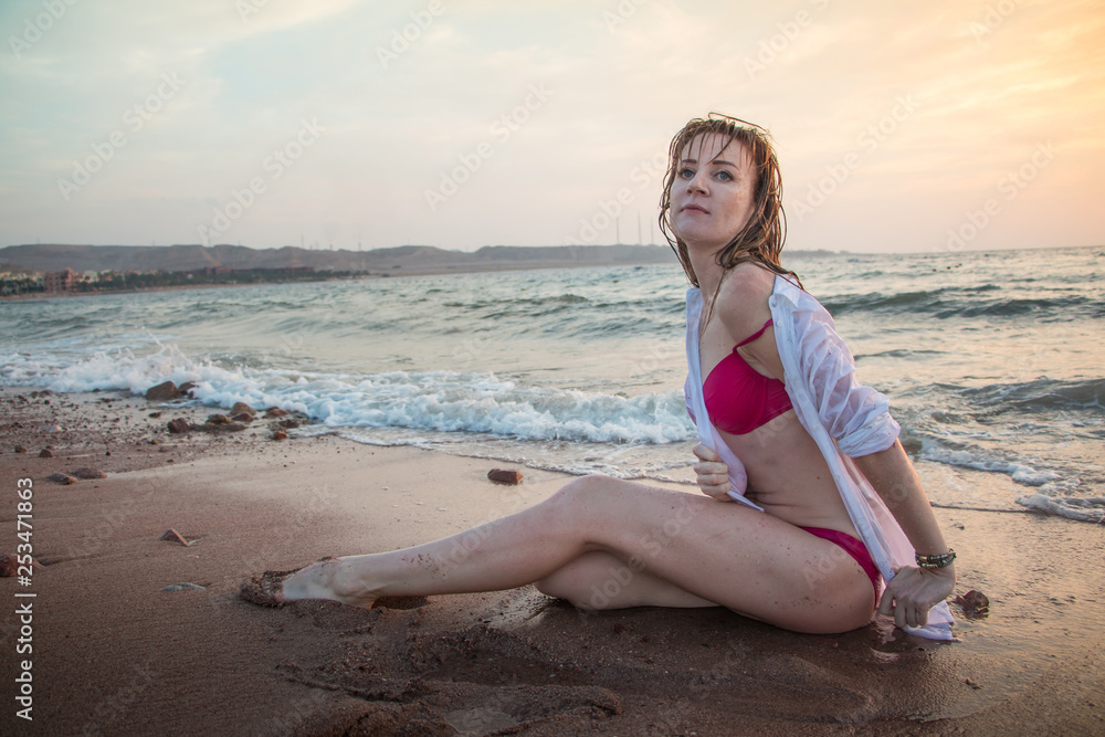 Girl rests and has fun in sea wave at sunset Girl rests and has fun in sea wave at sunset