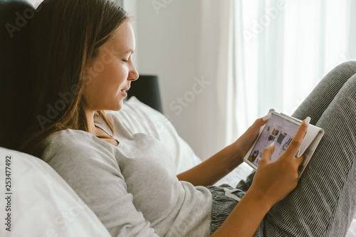 12-14 years teenag girl using tablet pc in room photo