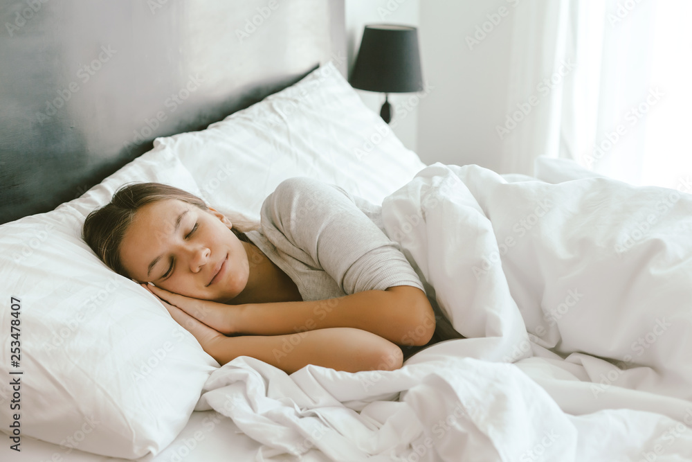 Girl sleeping in bed in hotel room Girl sleeping in bed in hotel room