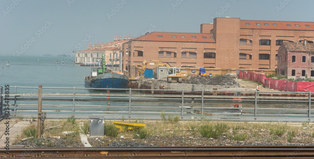Italy, train from Bolzano to Venice, a train sitting on the side of a building