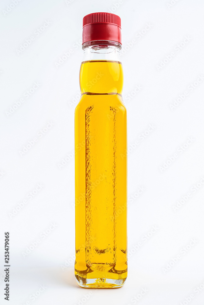 a bottle of golden linseed oil on a white background a bottle of golden linseed oil on a white background