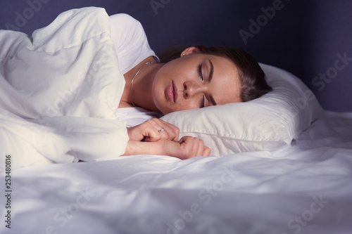 Beautiful young blonde woman sleeping in bed photo