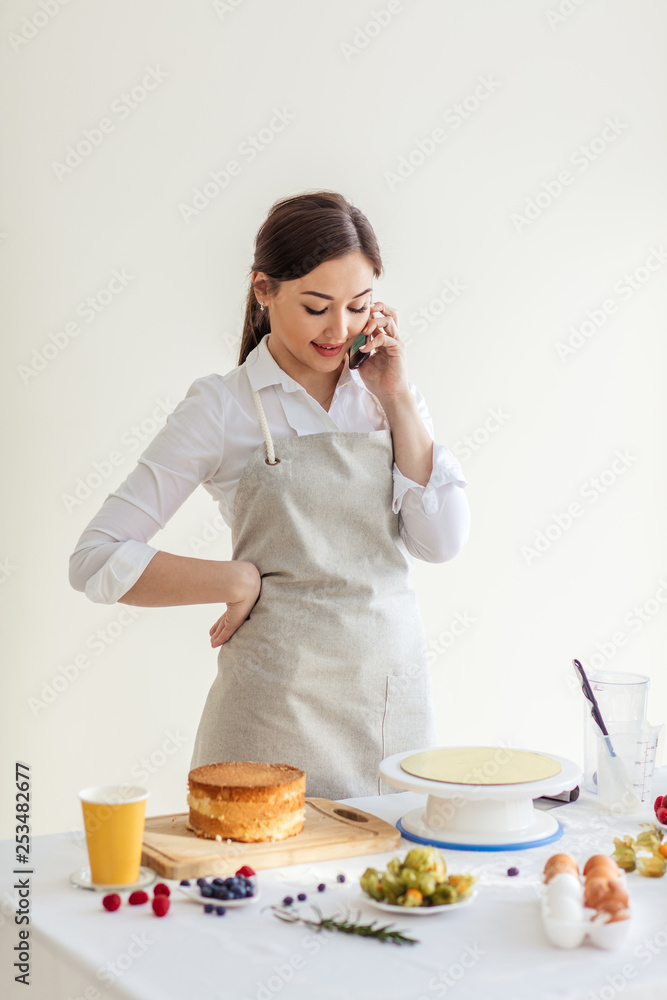 gorgeous good looking girl in apron talking with her boyriend while cooking at home, close up photo gorgeous good looking girl in apron talking with her boyriend while cooking at home, close up photo