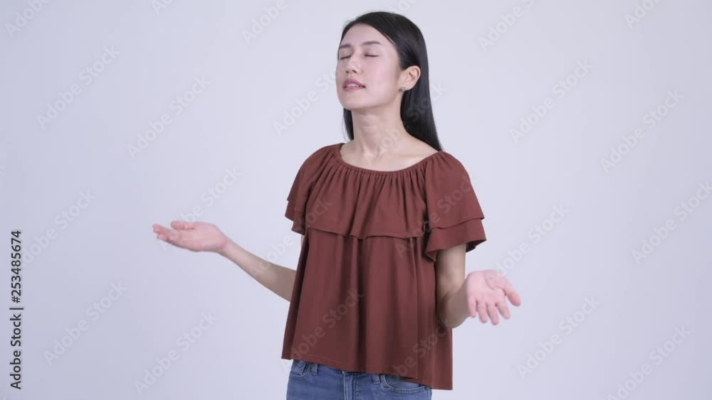 Happy beautiful Asian woman relaxing with eyes closed Happy beautiful Asian woman relaxing with eyes closed