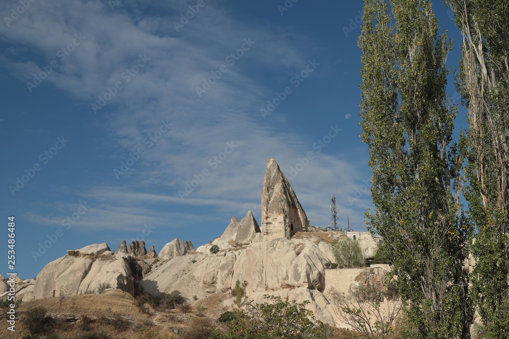 View of ancient Nevsehir cave town and a castle of Uchisar dug from a mountains in Cappadocia, Central Anatolia,Turkey View of ancient Nevsehir cave town and a castle of Uchisar dug from a mountains in Cappadocia, Central Anatolia,Turkey