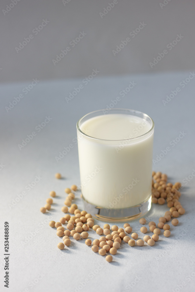 Soybean milk with soy beans around it Soybean milk with soy beans around it