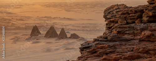 Background with the pyramids of Karima, Sudan, Africa, and the corner of the holy mountain Jebal Barkal in the foreground. photo
