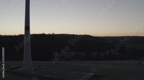 Drone ascending over a windwheel with sunrise background photo