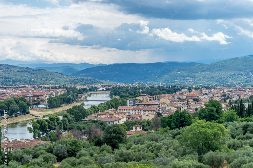 Italy,Florence, a view of a city with a mountain in the background