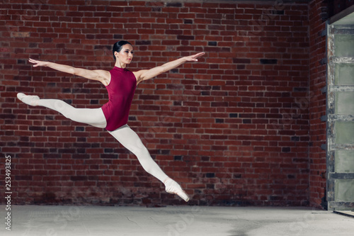 gymnast doing the split while jumping, full length photo. copy space, hobby, girl enjoys ballet © alfa27