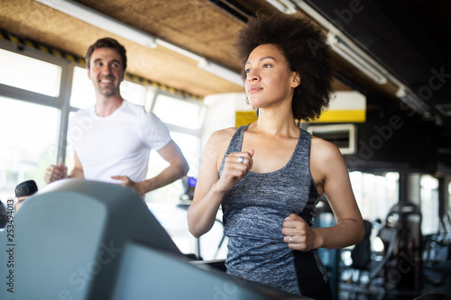 Fit people running in machine treadmill at fitness gym