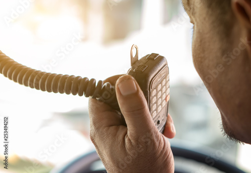 Truck Driver Making Talking Through Radio,Communication on the Highway,Concept transport on road,spot focus.