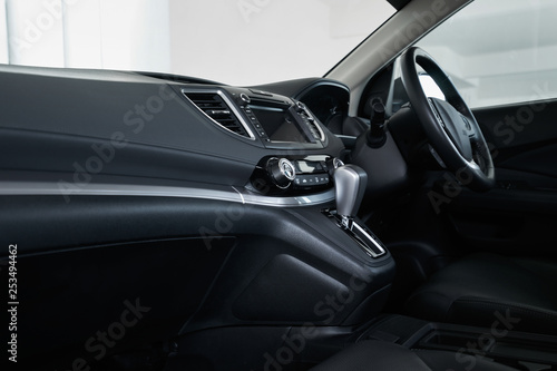 Modern black car dashboard interior , luxury car interior concept . Side profile angle . © jamesteohart