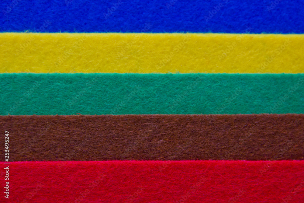 Pieces of coloured felt. Brown, red, turquoise, yellow and  blue color composition. Colorful felt texture for background with copy space.