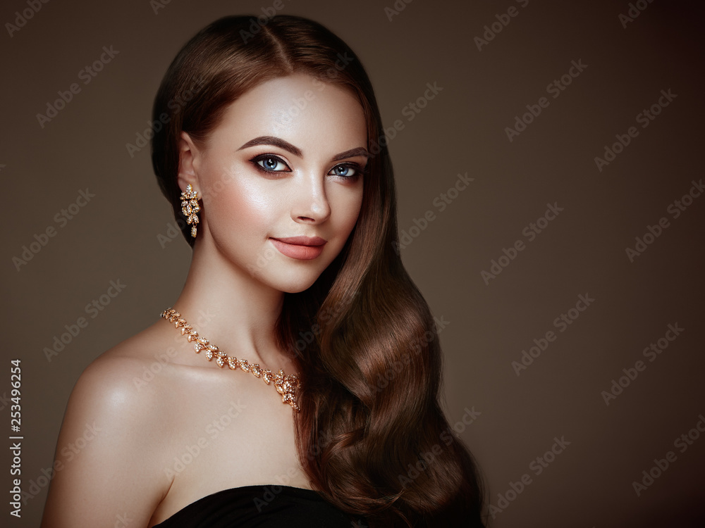 Brunette Girl with Long Healthy and Shiny Curly Hair. Care and Beauty. Beautiful Model Woman with Wavy Hairstyle. Make-Up and Jewelry Brunette Girl with Long Healthy and Shiny Curly Hair. Care and Beauty. Beautiful Model Woman with Wavy Hairstyle. Make-Up and Jewelry