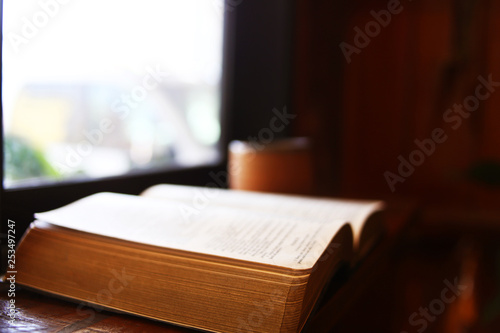 Bible books on wooden table at the coffee shop.