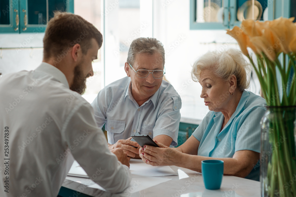 Fototapeta premium Senior couple talking with advisor