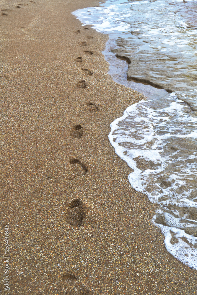 Footprints in the sand by the sea