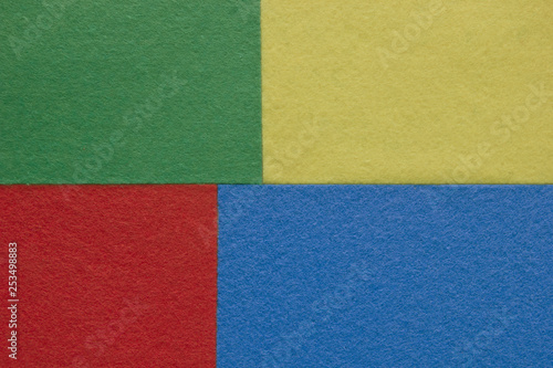 Pieces of coloured felt. Red, yellow, green and blue color composition. Colorful felt texture for background with copy space.