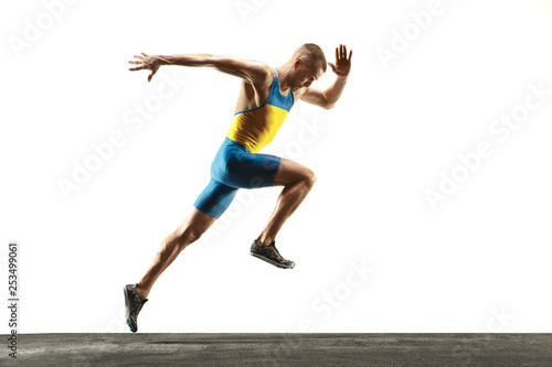 Slika na platnu Young caucasian man running isolated on white studio background