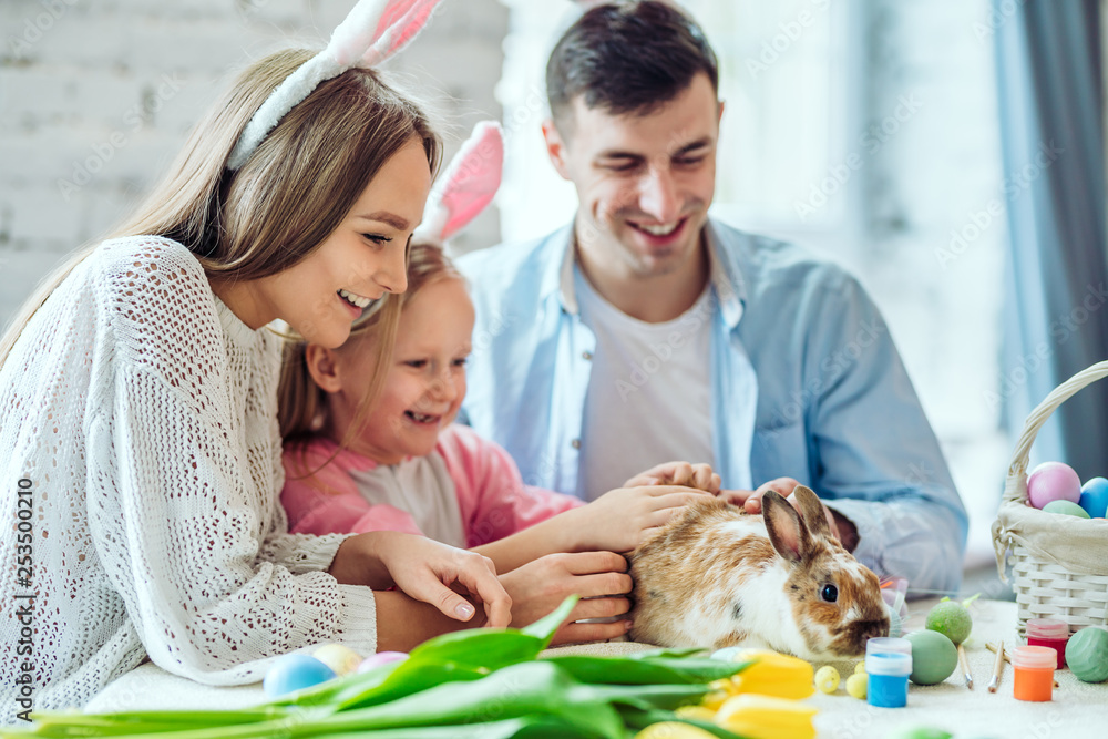 Rabbit is a symbol of Easter.Lovely family preparing for Easter together.In the spotlight home decorative rabbit.