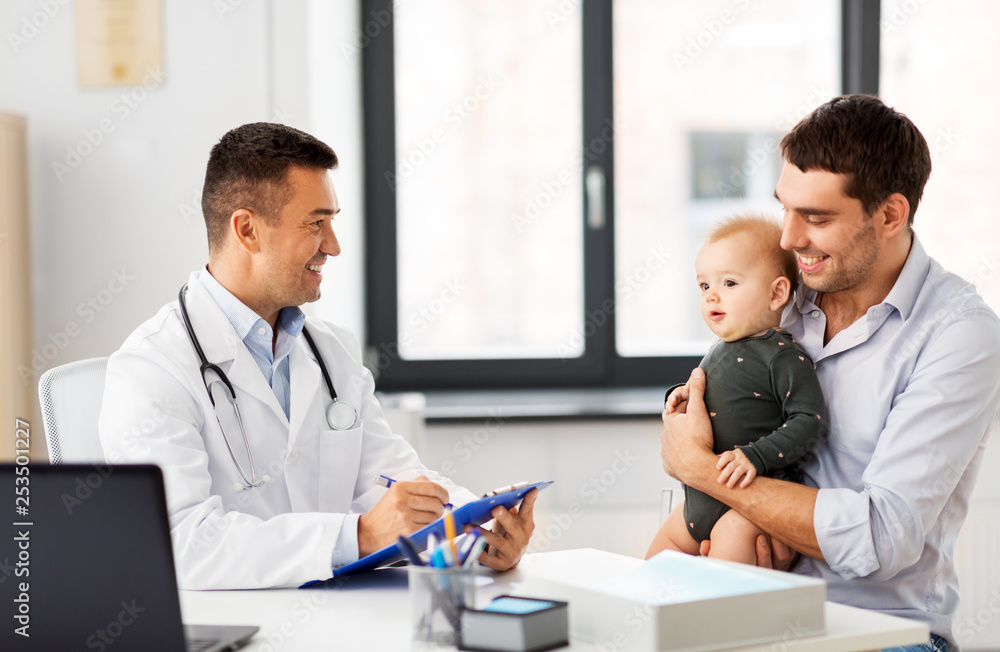 medicine, healthcare, pediatry and people concept - happy father with baby daughter and doctor with clipboard at medical office in hospital medicine, healthcare, pediatry and people concept - happy father with baby daughter and doctor with clipboard at medical office in hospital