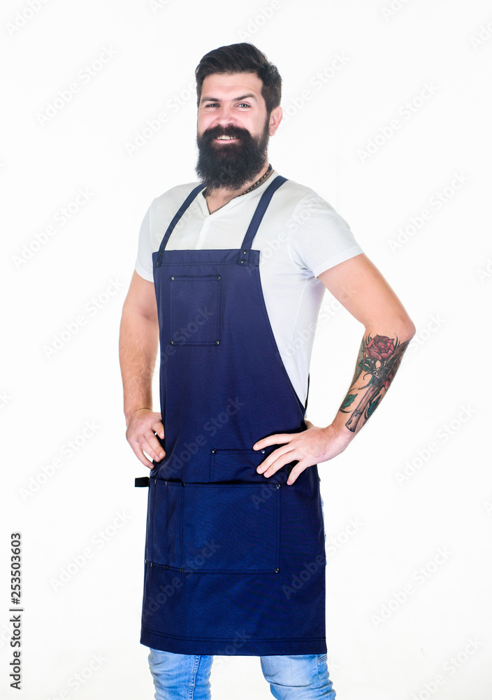 Apron for true guy at the grill. Master of grill in cooking apron with pockets. Bearded man in kitchen apron. Stylish grill cook keeping hands on hips. Cook with long beard wearing bib apron Apron for true guy at the grill. Master of grill in cooking apron with pockets. Bearded man in kitchen apron. Stylish grill cook keeping hands on hips. Cook with long beard wearing bib apron