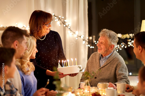 Photography celebration and family concept - happy family having birthday party at home
