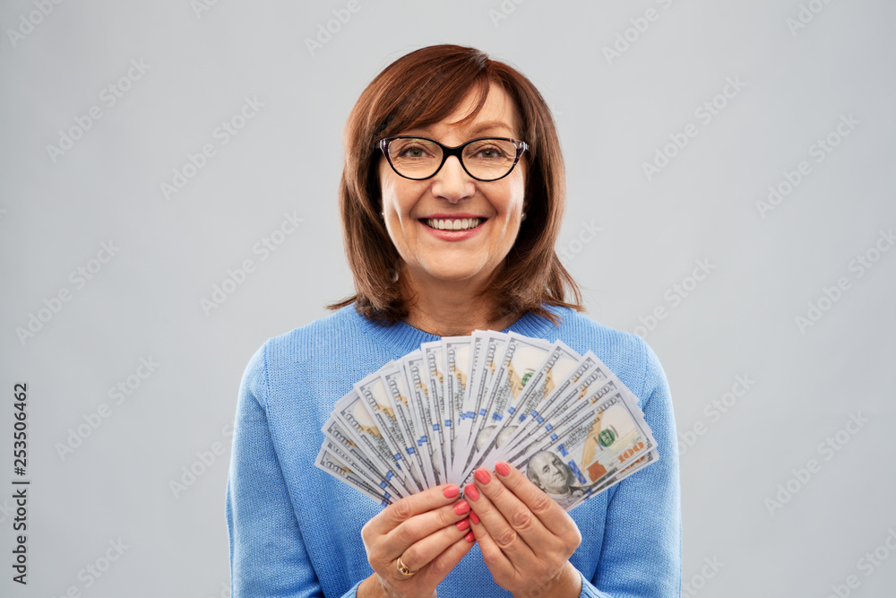 savings, finances and people concept - smiling senior woman holding hundreds of dollar money banknotes savings, finances and people concept - smiling senior woman holding hundreds of dollar money banknotes