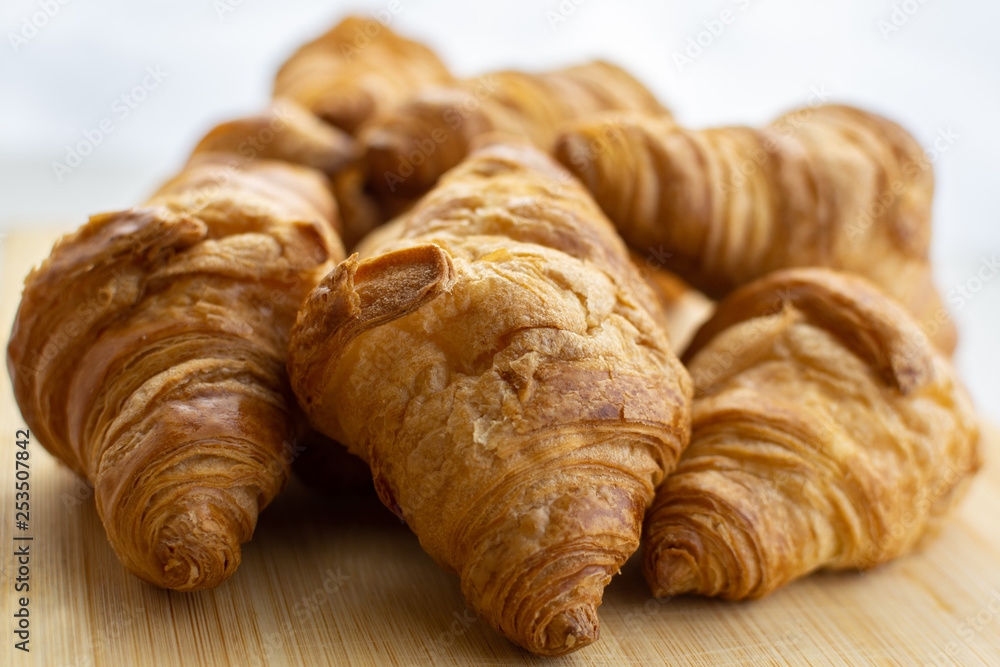 Fresh baked croissants on white background