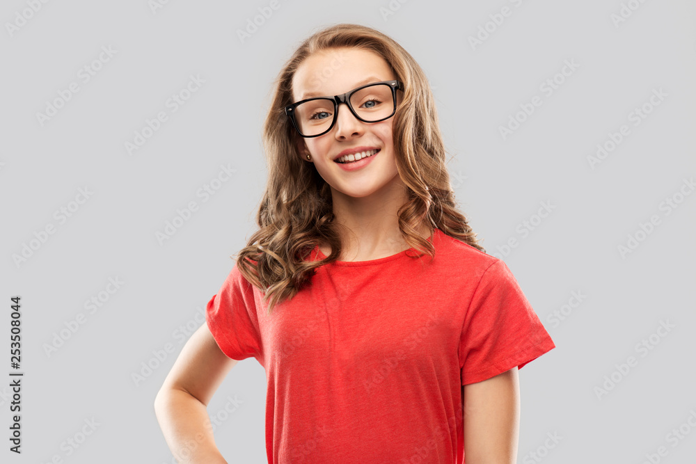 education, school and people concept - smiling teenage student girl in glasses and red t-shirt over grey background