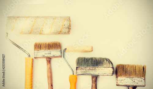Wall paint brushes and imstruments for painting on the white background, well used with copy space for text.