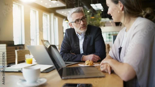 Salesman and manager discussing ideas in modern office space