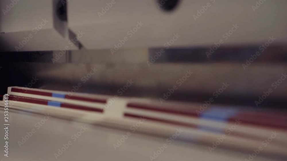 Machine slicing a stack of tickets. Machine slicing a stack of tickets.