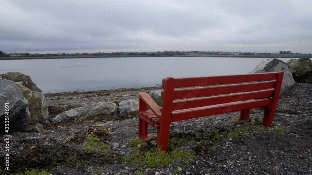 Red bench overlooking the sea in Galway, Ireland. Red bench overlooking the sea in Galway, Ireland.